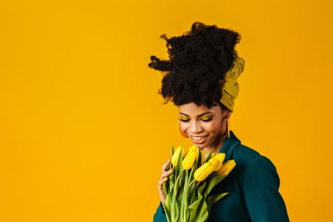 Portrait of smiling Black woman with tulips