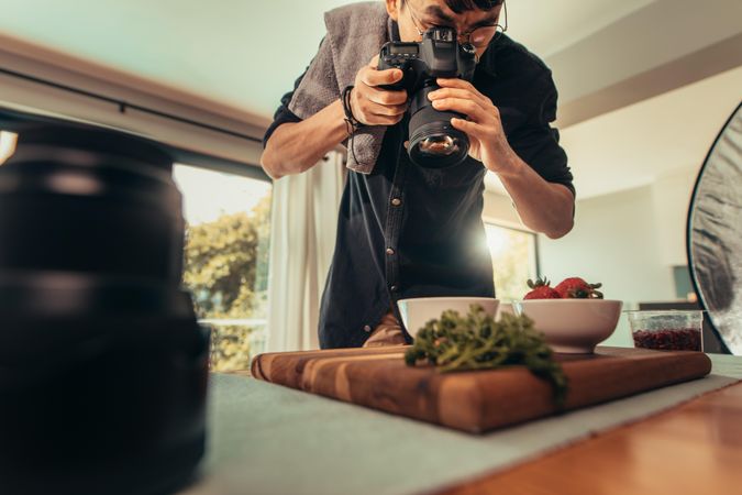 Food photographer capturing spread of food from above