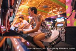 Happy couple having fun playing arcade racing games at a gaming parlour 41wYO0