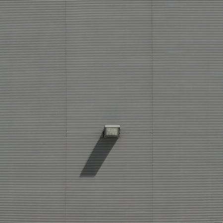 Grey lamp detail on side of building