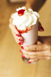 ice cream in paper cone in hands