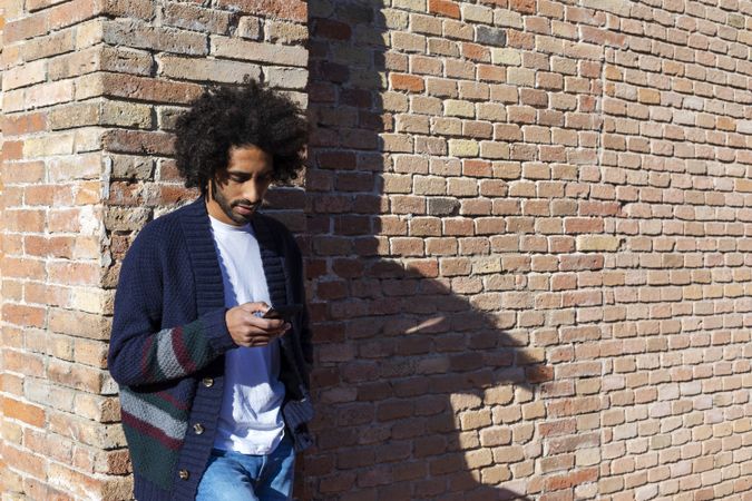 Young man using cellphone outdoor