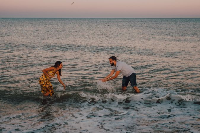 Active lovely couple having fun in foamy water