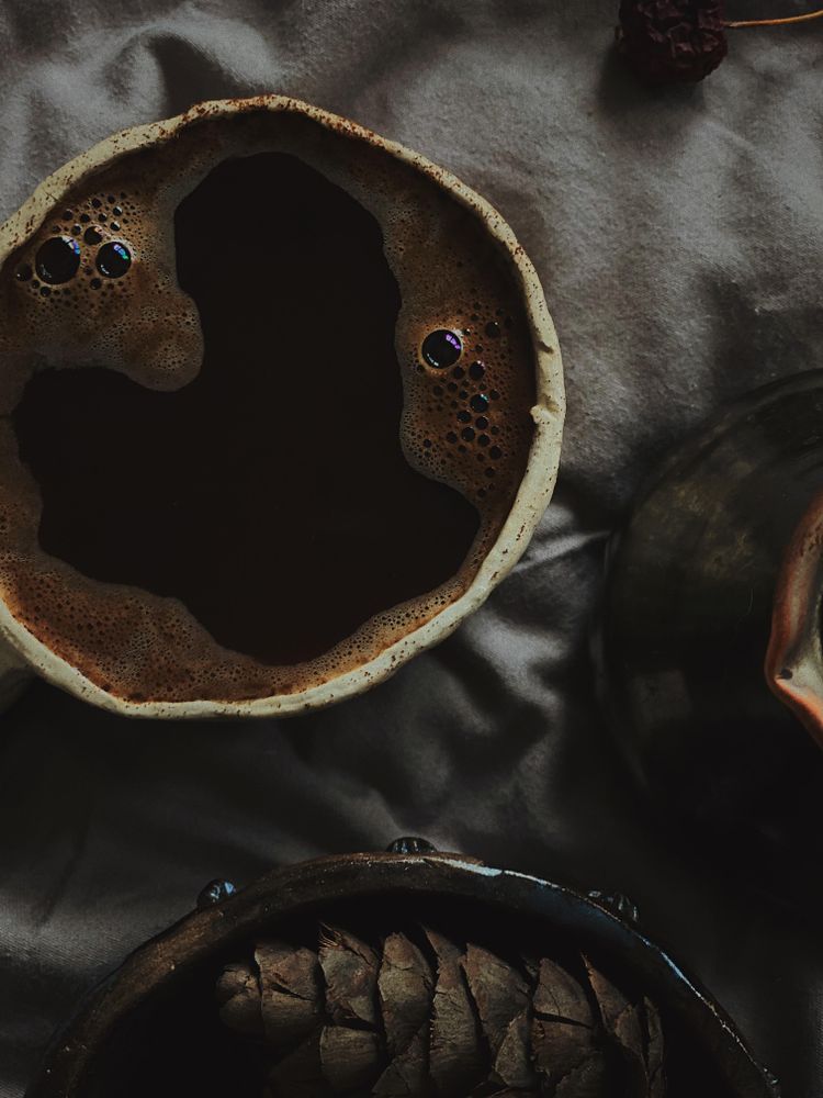 Close up of coffee cup on bed
