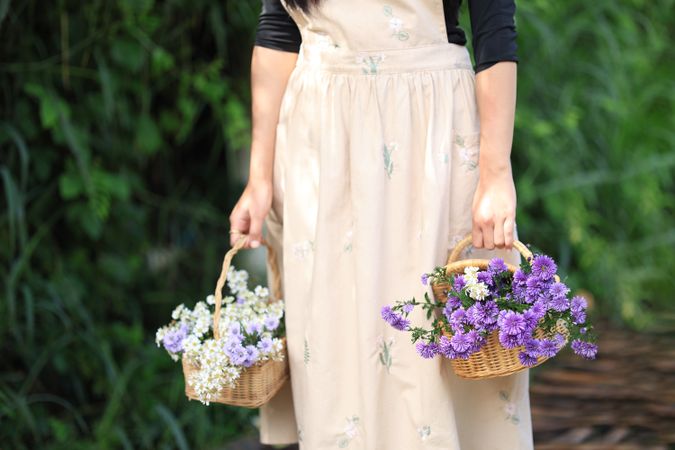 Woman in the Meadow Field Enjoys and Collects a Bouquet of Purple and Pink Peacock