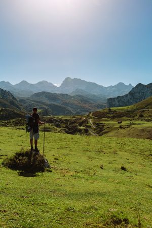 Mountaineer looking landscape with path between mountains