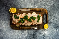 Top view of freshly baked lemon cake dessert with mint garnish on wooden board and copy space
