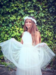 Happy girl in white dress smiling in summer park