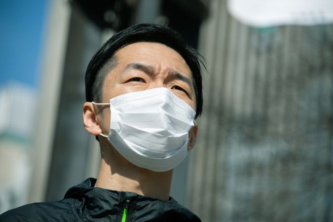 Man with facemask standing outdoor