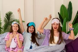 Three cheerful girls celebrating recovery at home.