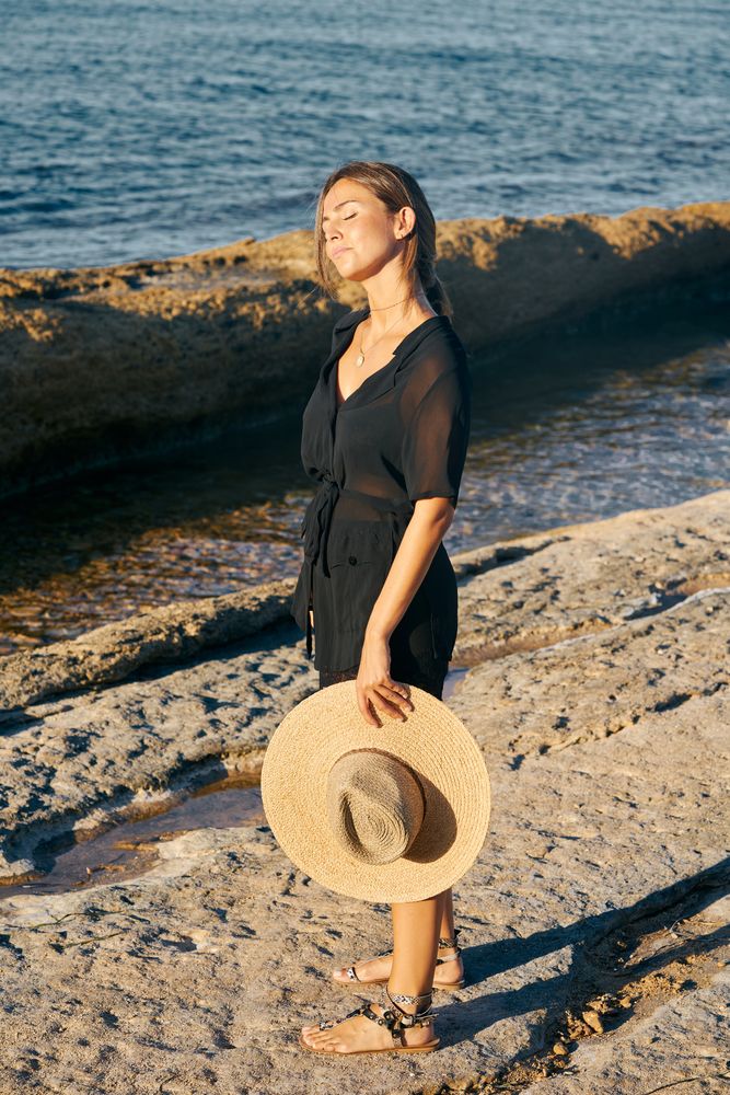 Calm woman enjoying sun on beach