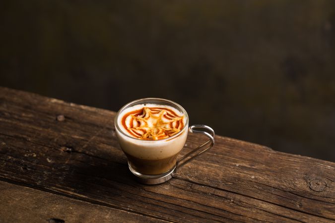 Cups of tasty hot coffee drink on wooden table
