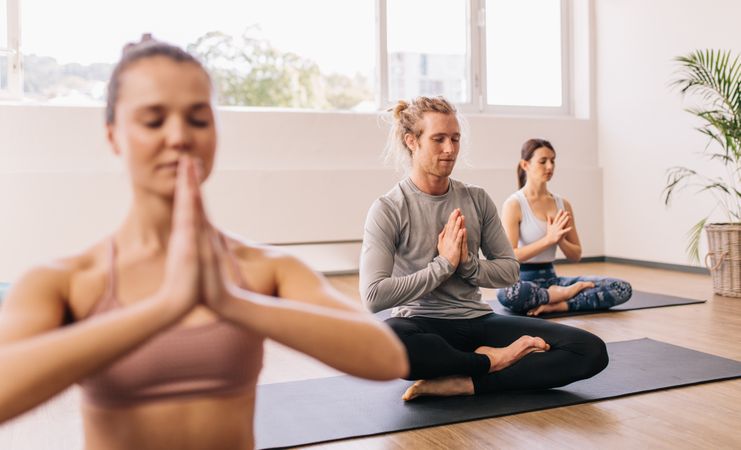 People meditating in yoga class