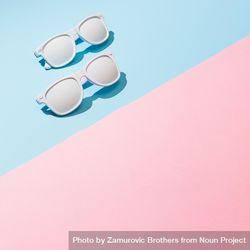 Painted sunglasses with pastel pink and blue background bYKa65