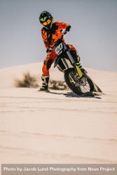 Motocross bike rider riding over sand dune 4BOYPb