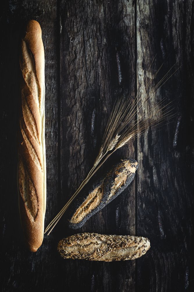 Assorted gold homemade bread on dark wood background