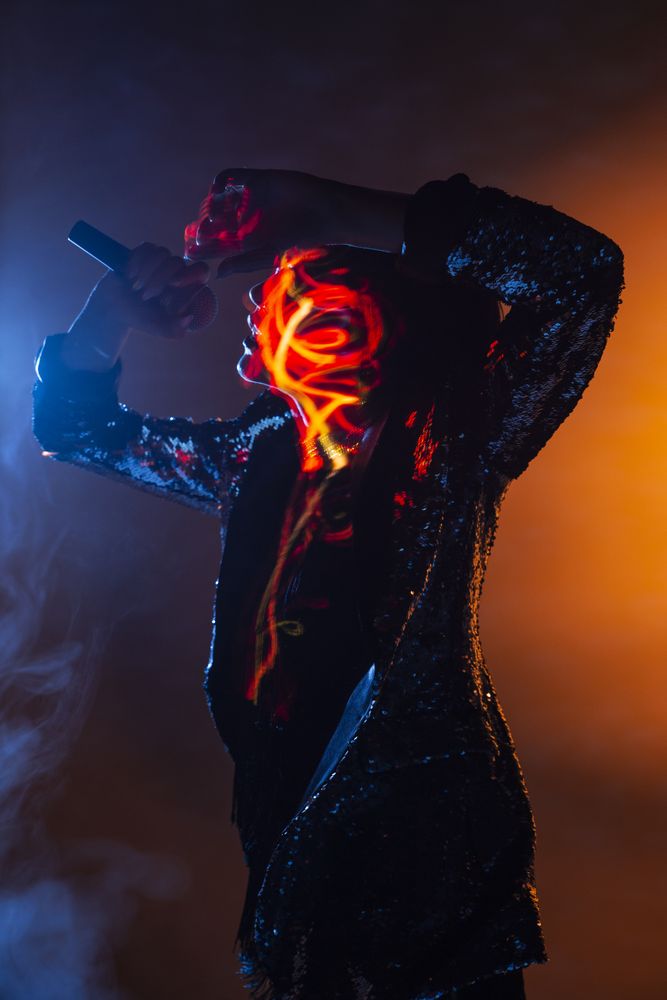 Stylish woman singing on stage