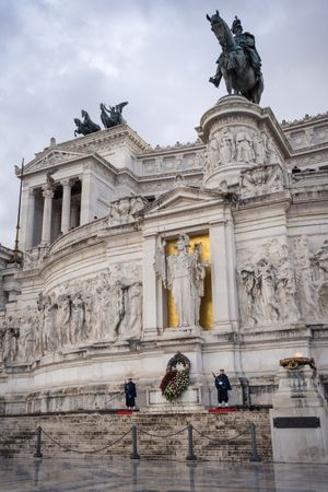 Soldiers guarding ancient monument on cloudy day
