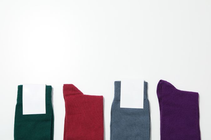 Socks with blank label on light background, space for text
