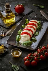 Caprese salad served on rectangular dish