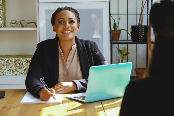 Smiling business owner taking a meeting in bright office