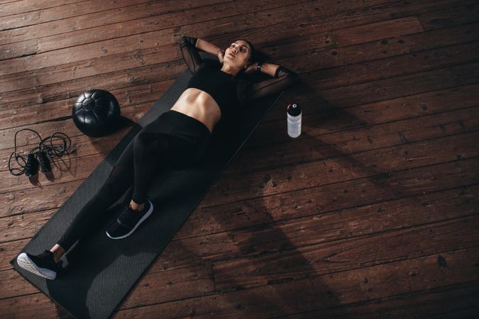 Fitness woman resting after cardio workout at gym