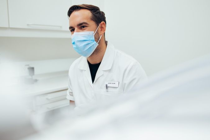 Dentist wearing face mask in office