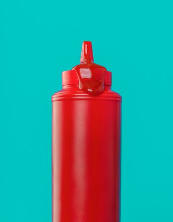 Ketchup bottle close up, isolated on a blue background
