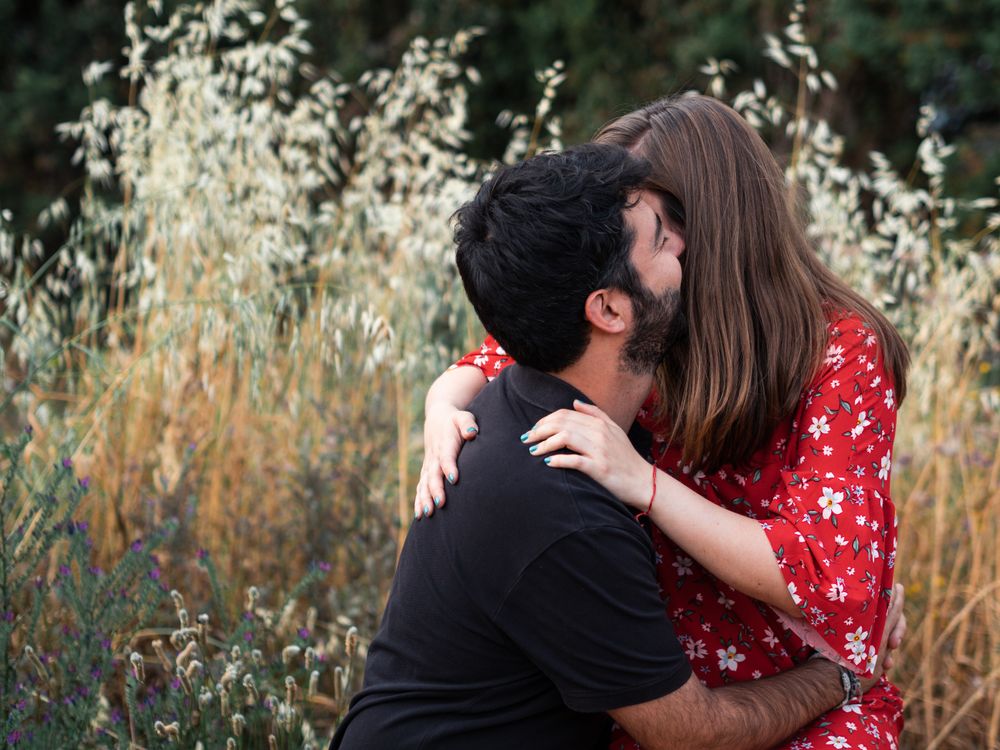 Young happy couple embracing in beautiful garden