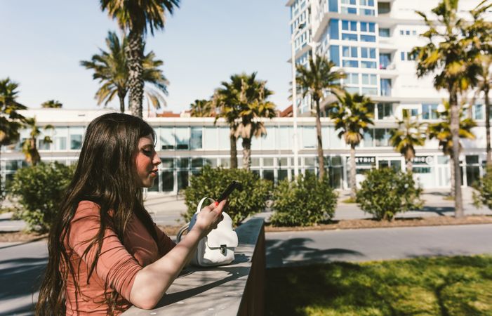 Teen girl looking at her smartphone.