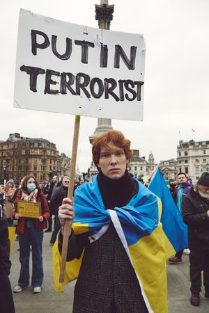 London, England, United Kingdom - March 5 2022: Red haired person with “Putin Terrorist” sign