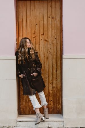 Female near wooden door