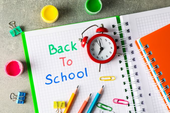 Composition with school supplies on grey background, top view