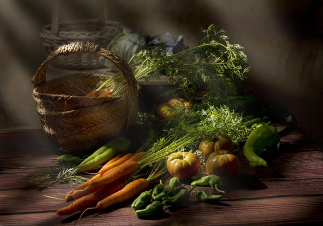 Vegetable still life in sunlight on wooden table