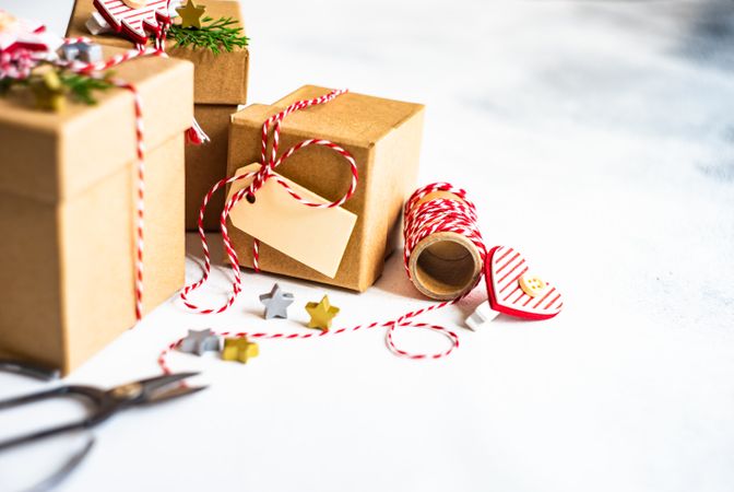 Brown Christmas presents with scissors and string