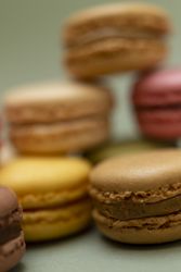 Pile of a variety of French macaroon on a green table