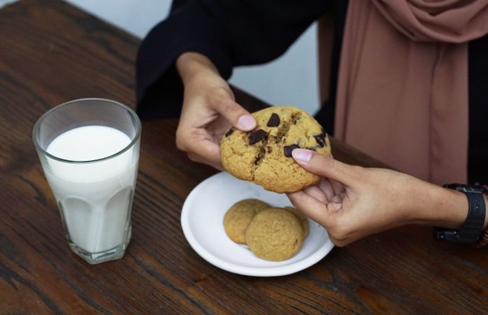 Breaking cookies apart with milk on side