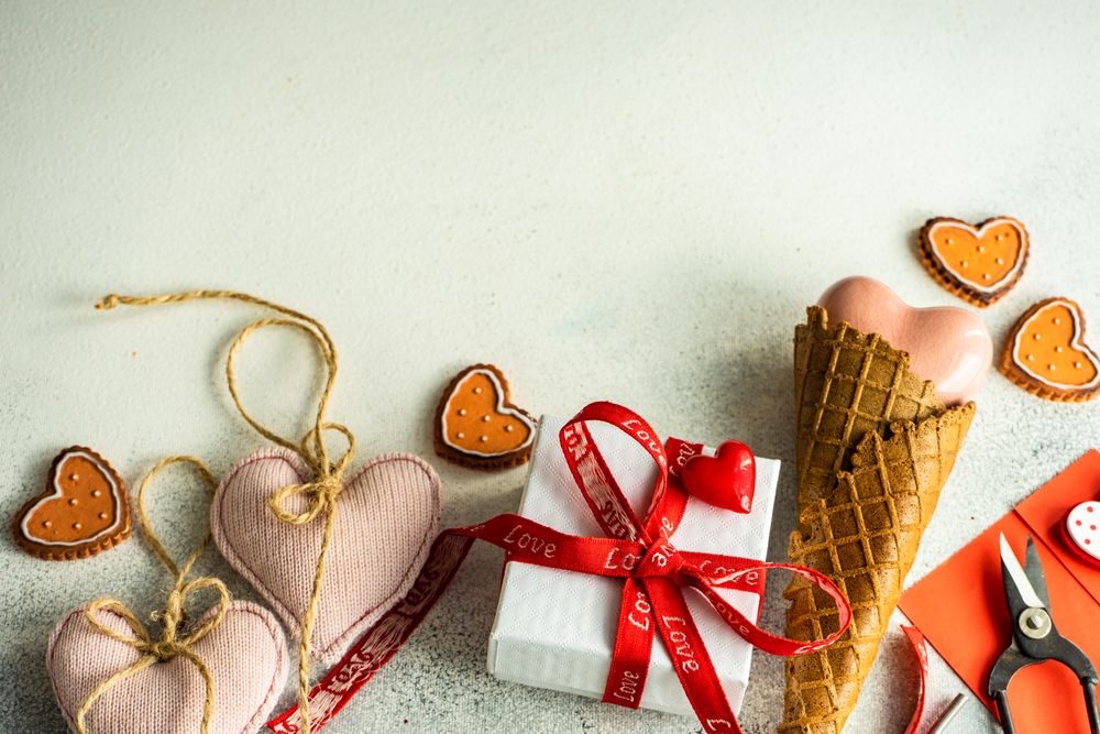 Gift with red ribbon and heart ornaments