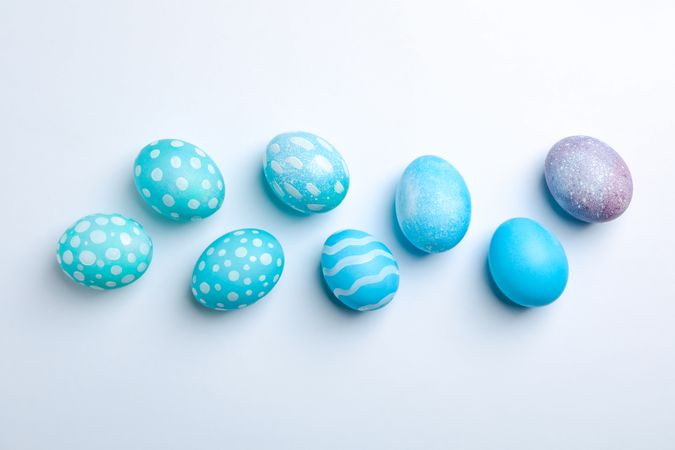 Flat lay composition with Easter eggs on neutral background, space for text