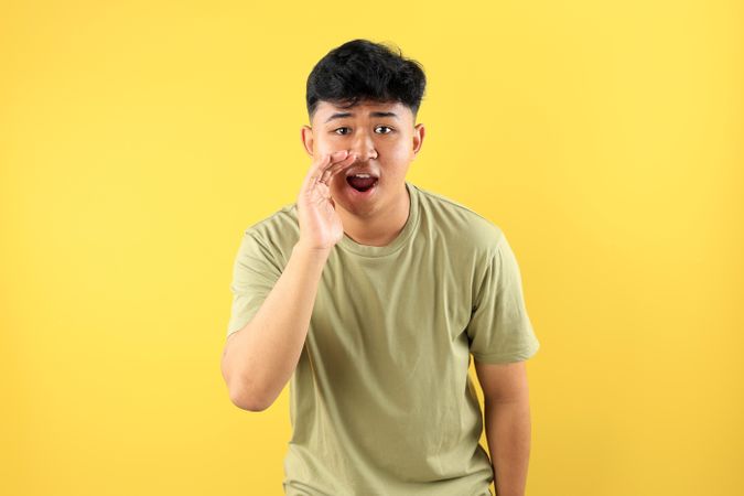 Young Asian Mand Hand on Mouth Telling Secret Rumor, Whispering Malicious Talk Conversation