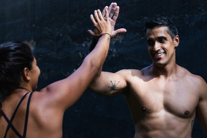 Sportive Hispanic couple giving high five