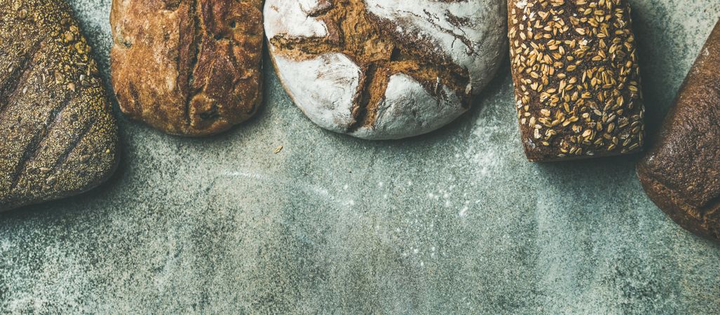 Healthy homemade bread loaves against grey background