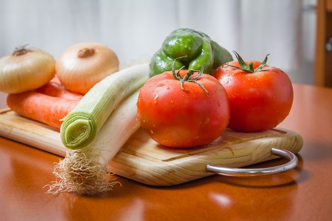 Fresh vegetables on cutting board in the kitchen