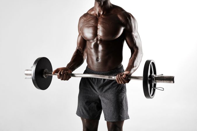 Cropped shot of Black male exercising with barbell