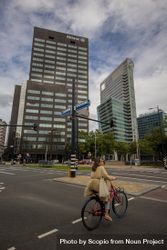Woman riding a bicycle in the city of Rotterdam, Netherlands 5w8164