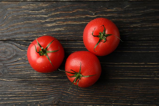 Fresh ripe tomatoes on wooden background, top view