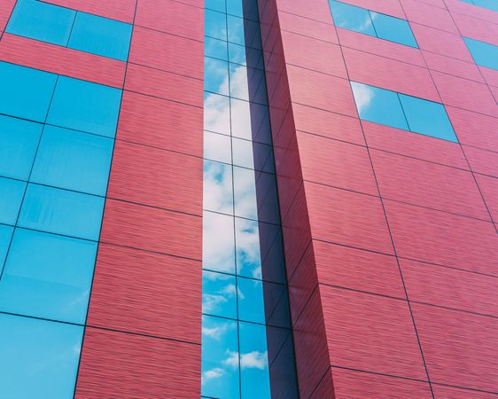 Close-up of red concrete and glass building