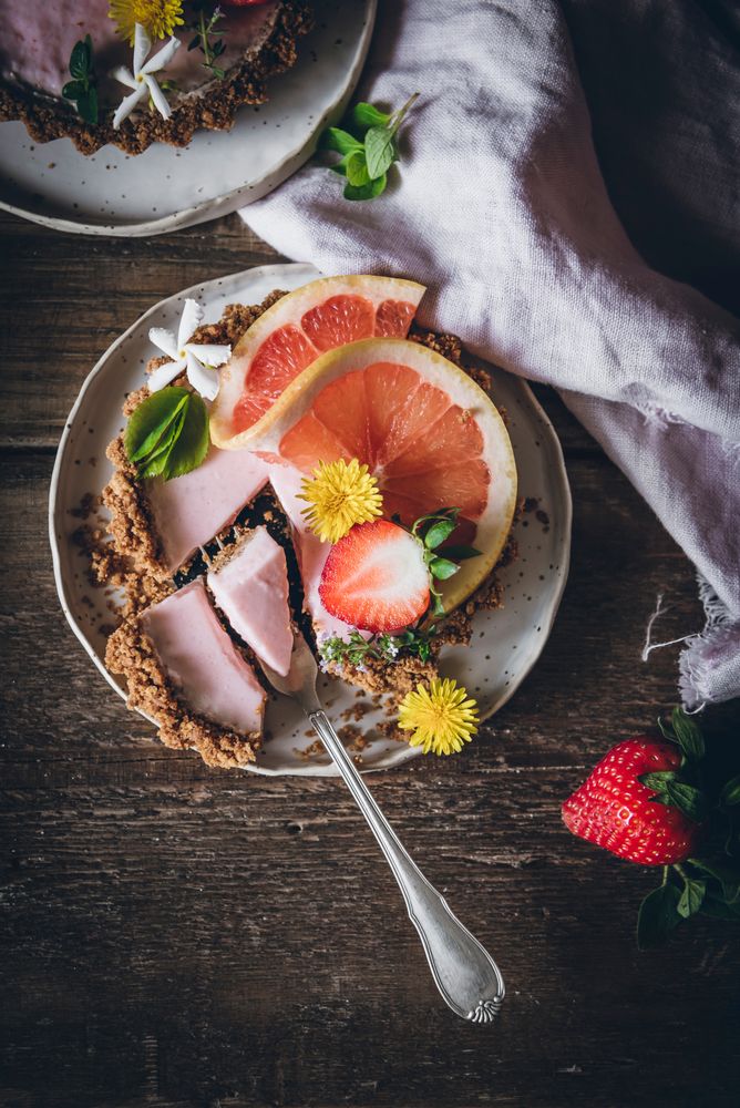 Strawberry and citrus cake served on wooden table