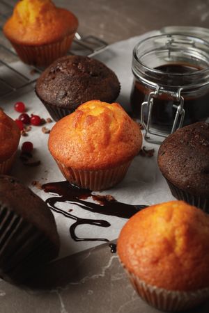Composition with delicious muffins, berries, chocolate and baking paper