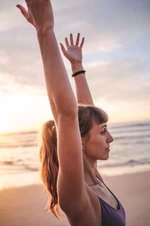 Fit woman with hands stretched upwards